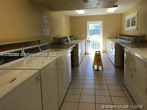 common laundry area featuring light tile patterned flooring and washer and dryer