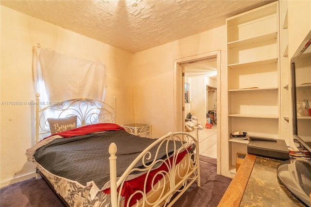 bedroom featuring carpet floors and a textured ceiling