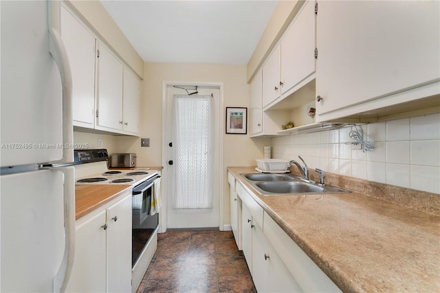 kitchen with light countertops, white appliances, white cabinets, and a sink