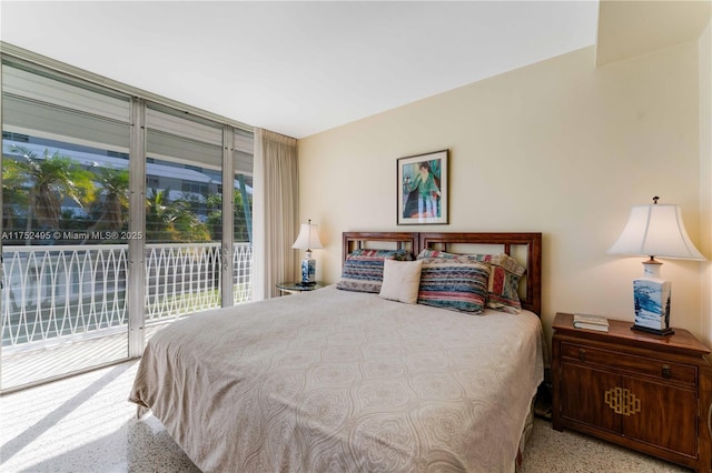 bedroom featuring access to outside and speckled floor