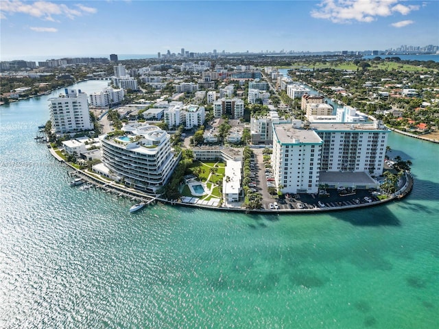 birds eye view of property with a water view and a view of city