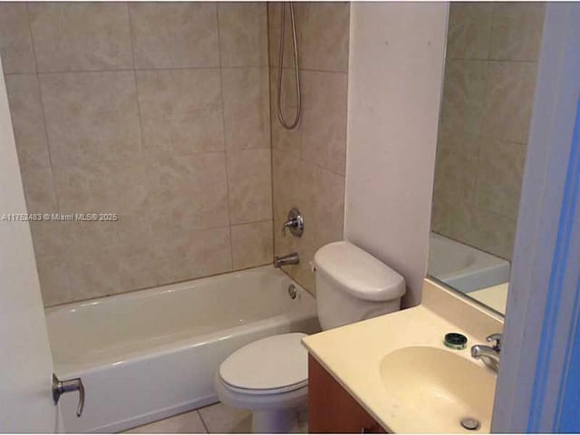 bathroom featuring vanity, bathing tub / shower combination, tile patterned flooring, and toilet