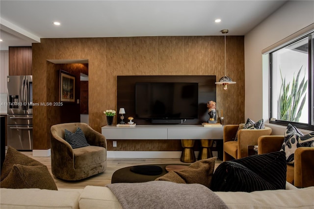 living room featuring light wood-style flooring and recessed lighting