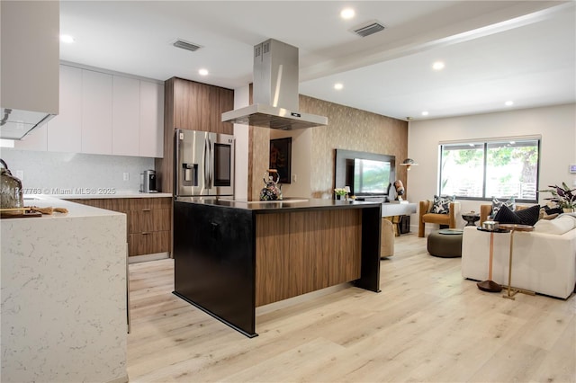 kitchen with white cabinets, modern cabinets, island exhaust hood, and brown cabinets