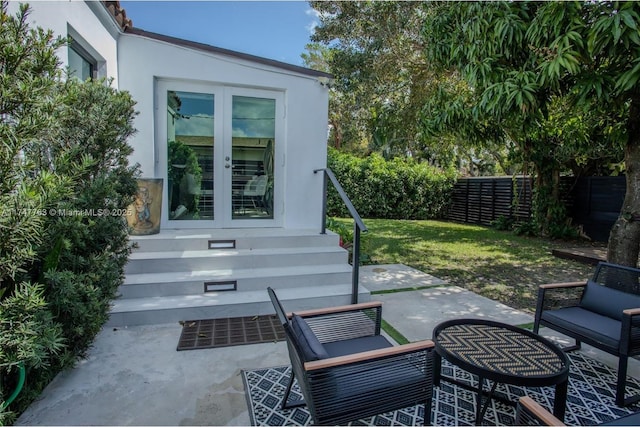 view of patio featuring entry steps, a fenced backyard, and french doors