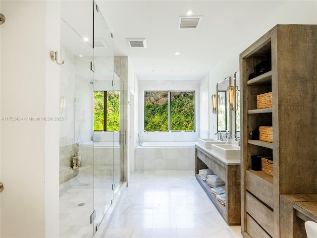 bathroom with a wealth of natural light, visible vents, a garden tub, and a shower stall