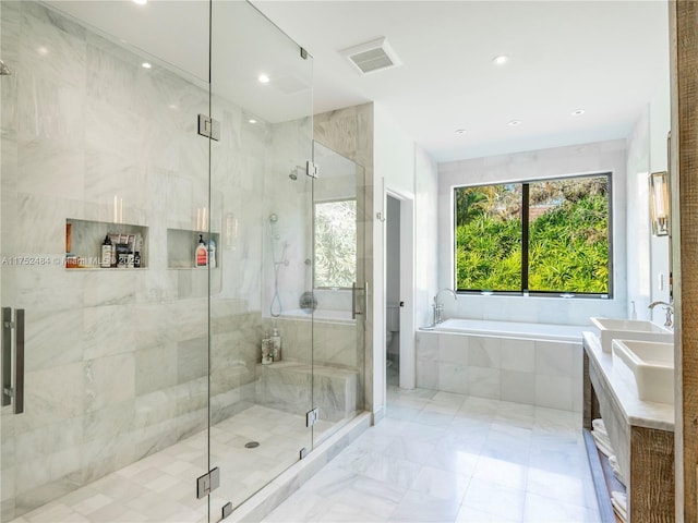 bathroom with a stall shower, visible vents, toilet, a sink, and a bath