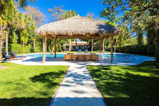 view of community with a patio area, a swimming pool, a lawn, and a gazebo