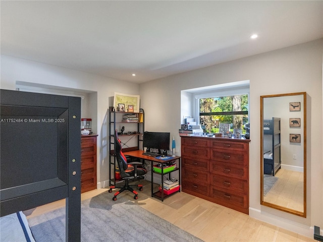 office area featuring baseboards, light wood finished floors, and recessed lighting