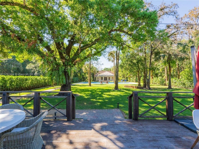 exterior space with a deck, a yard, and a gazebo