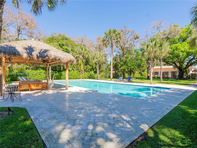 outdoor pool with a gazebo, an outdoor living space, a patio, and a lawn