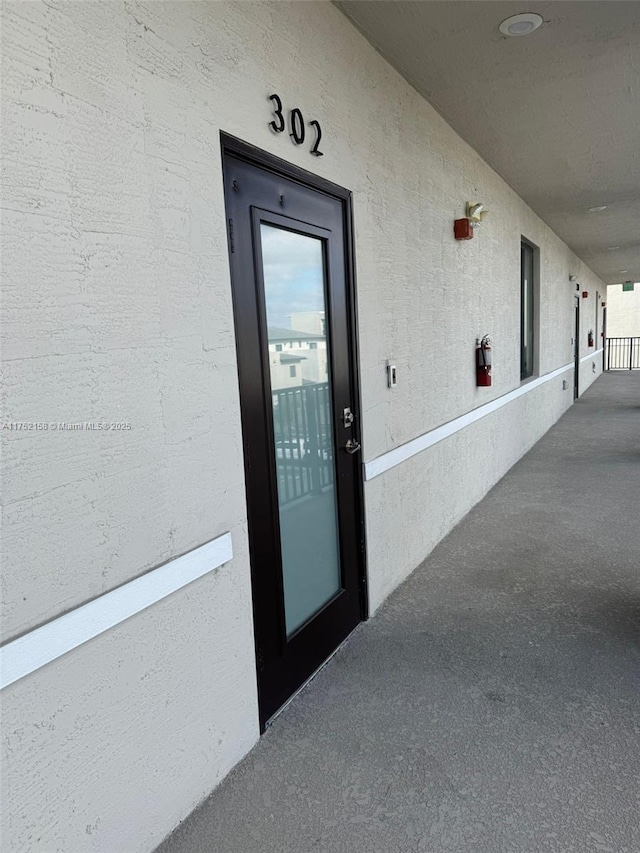 property entrance featuring stucco siding