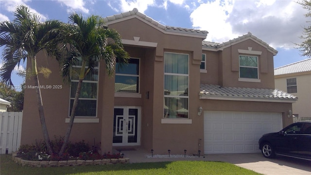 view of front of property with driveway, a tiled roof, and stucco siding