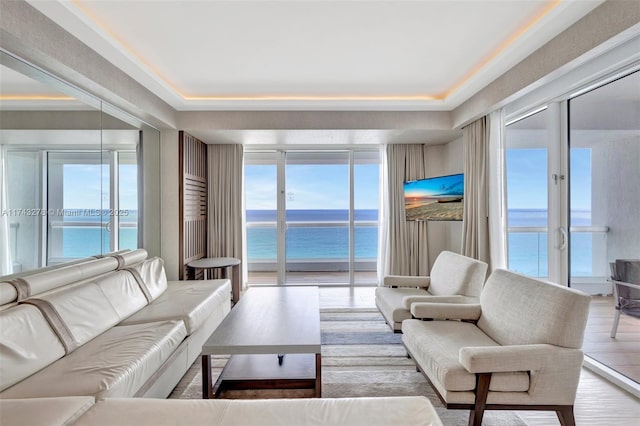 living area with a water view and wood finished floors