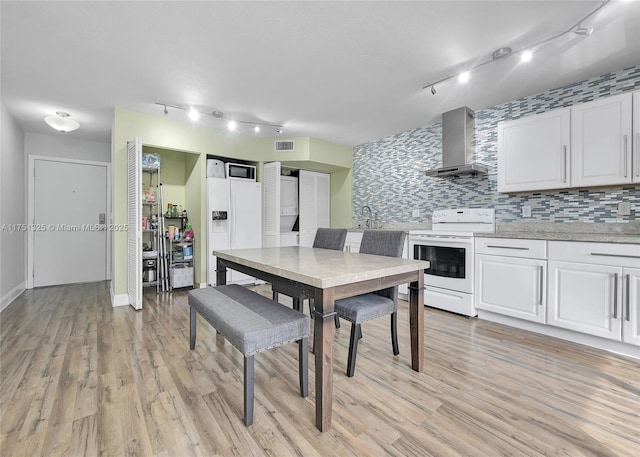 dining room featuring light wood-style floors and visible vents