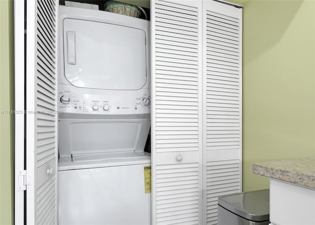 laundry room featuring stacked washer and dryer and laundry area