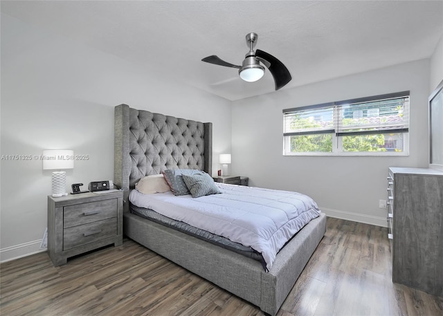 bedroom featuring dark wood-style floors, ceiling fan, and baseboards