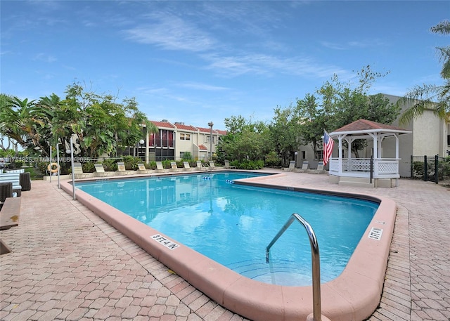 pool featuring a gazebo and fence