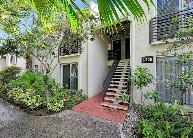 doorway to property featuring stucco siding