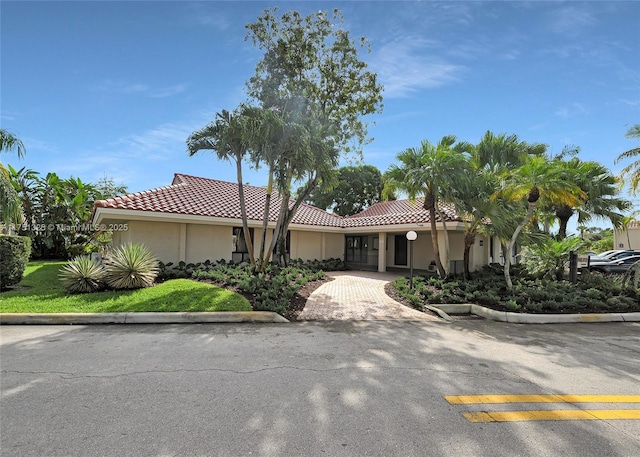 view of front of home with a tile roof and stucco siding