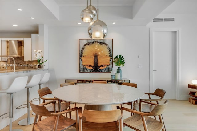 dining area featuring recessed lighting, visible vents, and light wood finished floors