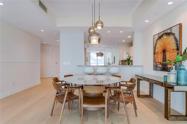 dining room featuring recessed lighting, baseboards, visible vents, and light wood finished floors