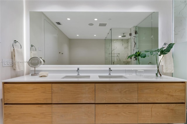 full bath featuring visible vents, vanity, and a marble finish shower