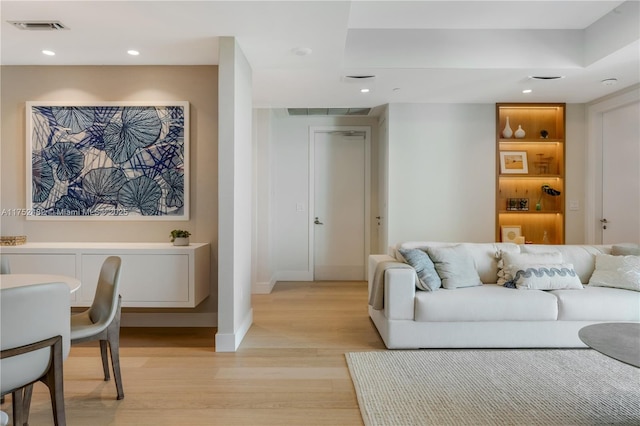 living area with light wood-type flooring, baseboards, visible vents, and recessed lighting