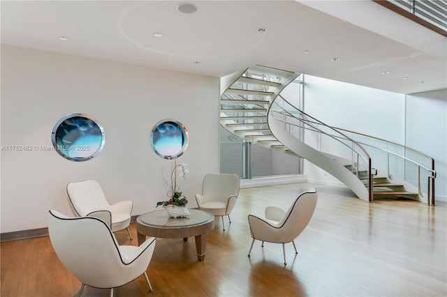 interior space with stairway, baseboards, and wood finished floors