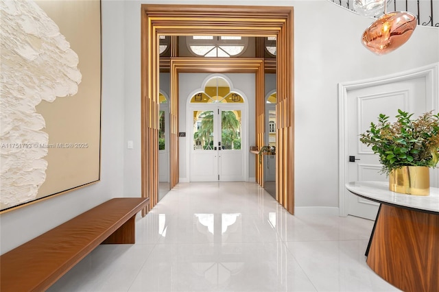 interior space with french doors and baseboards