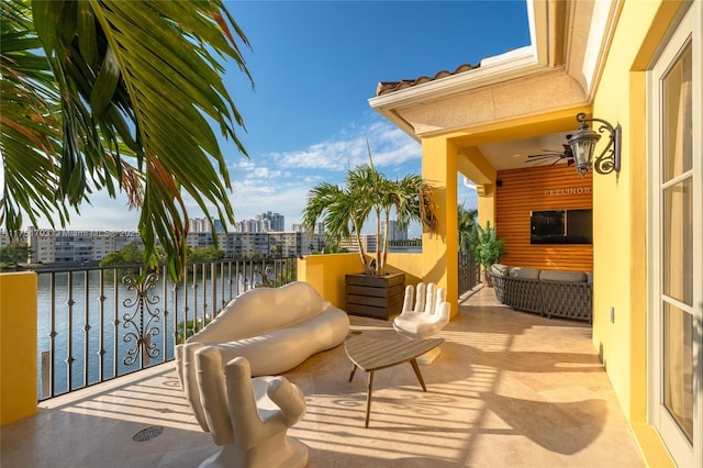 view of patio / terrace with ceiling fan and a balcony