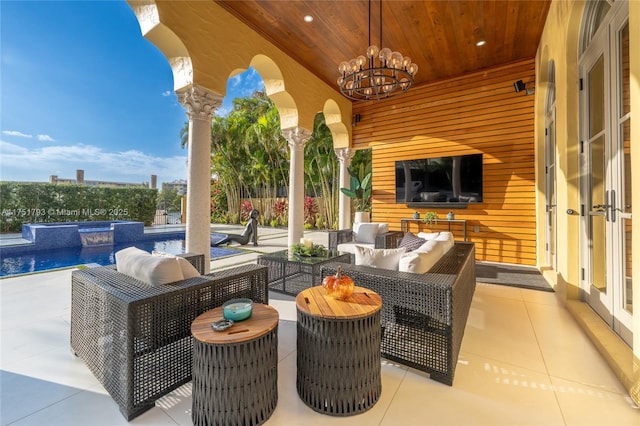 view of patio / terrace featuring outdoor lounge area, a fenced in pool, and an in ground hot tub