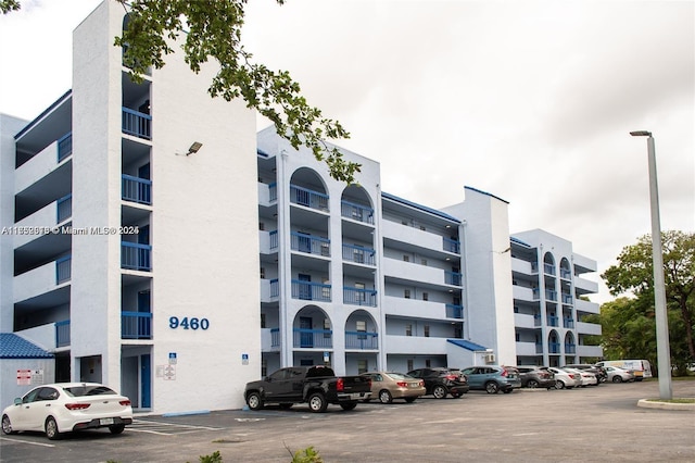 view of property featuring uncovered parking