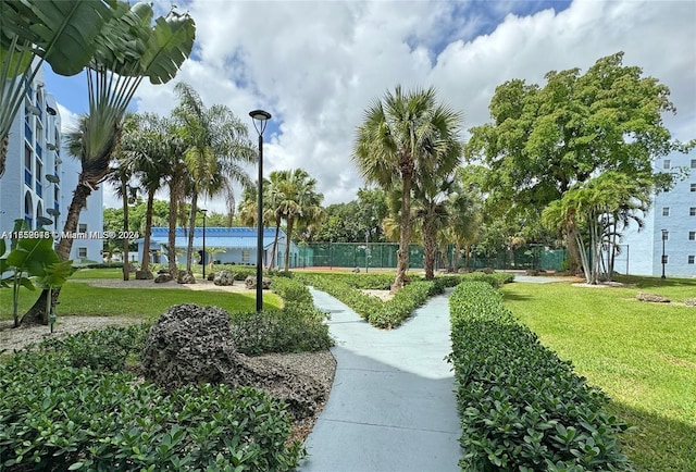 view of community with a yard and fence