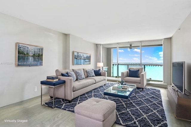 living area with expansive windows and wood finished floors