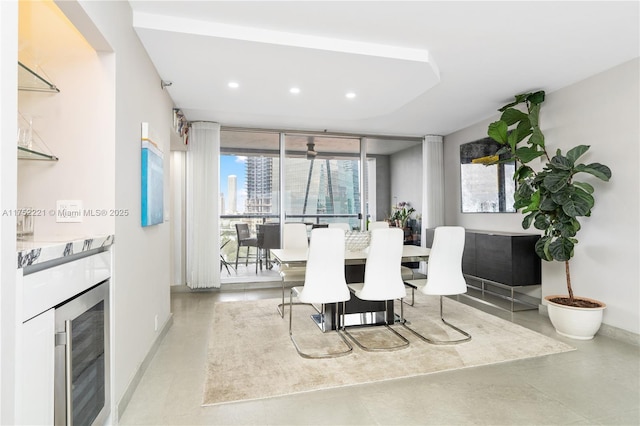 dining area with beverage cooler, baseboards, a view of city, and recessed lighting