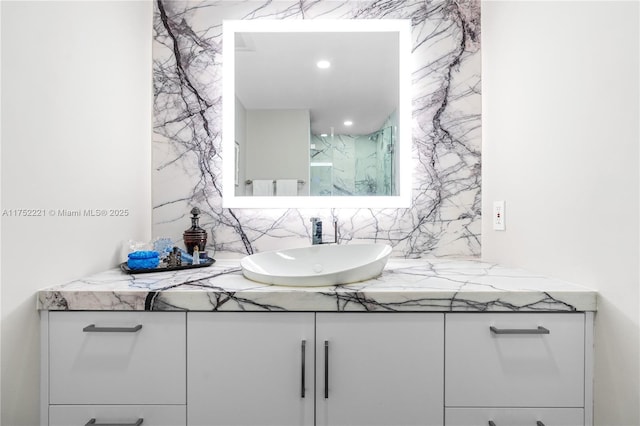 bathroom with recessed lighting, backsplash, and vanity