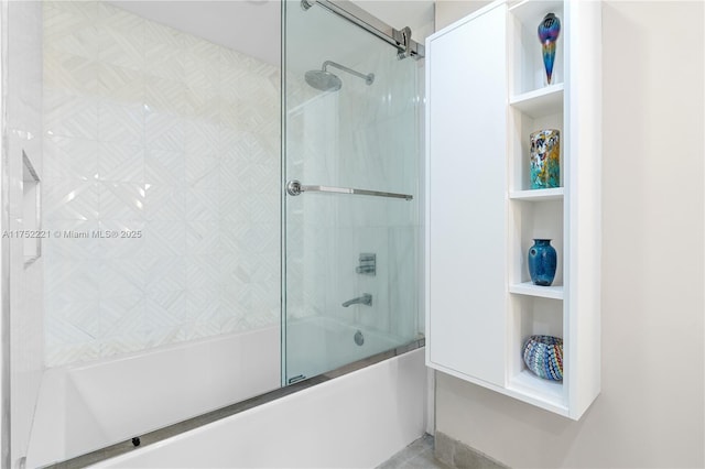 bathroom with bath / shower combo with glass door