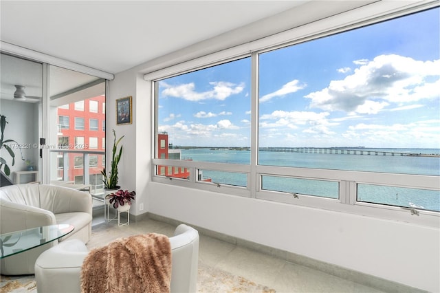 sunroom / solarium featuring a water view