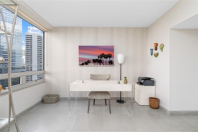 office with a view of city, tile patterned flooring, and baseboards