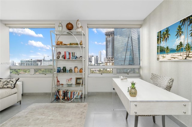 interior space with a view of city and baseboards