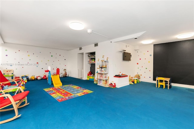 game room featuring baseboards, visible vents, and carpet flooring