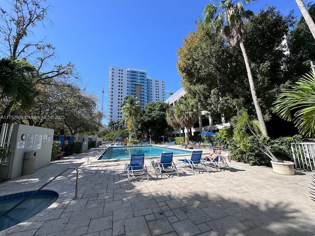 pool with fence and a patio