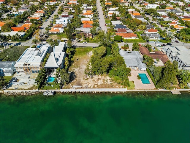 bird's eye view featuring a water view and a residential view