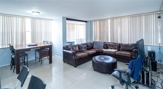 living room featuring light tile patterned floors and baseboards