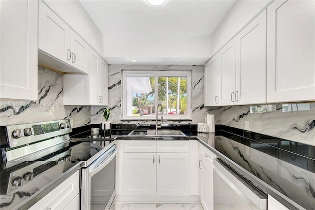 kitchen featuring a sink, white cabinets, dishwasher, dark countertops, and stainless steel range with electric stovetop