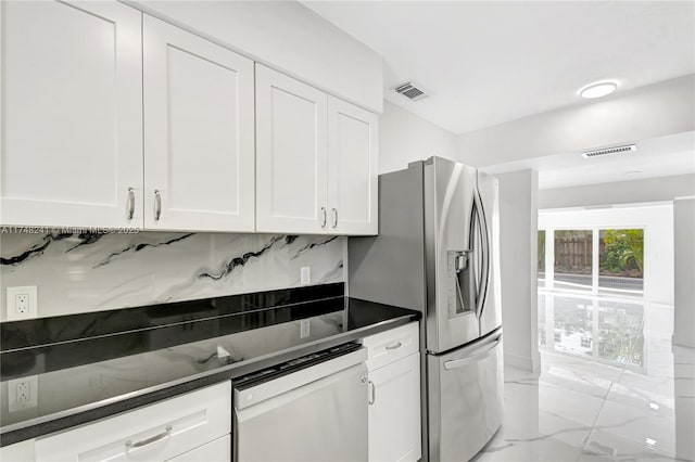 kitchen featuring visible vents, dark countertops, marble finish floor, and white dishwasher