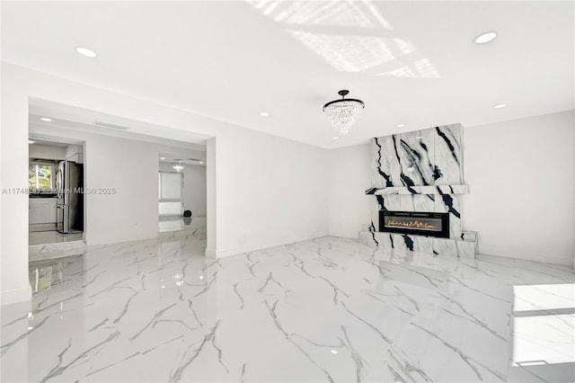 unfurnished living room with recessed lighting, marble finish floor, and a large fireplace