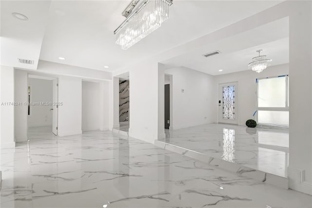 unfurnished room with recessed lighting, visible vents, a notable chandelier, and marble finish floor