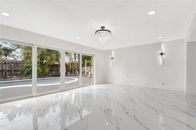 empty room featuring recessed lighting, marble finish floor, french doors, and an inviting chandelier
